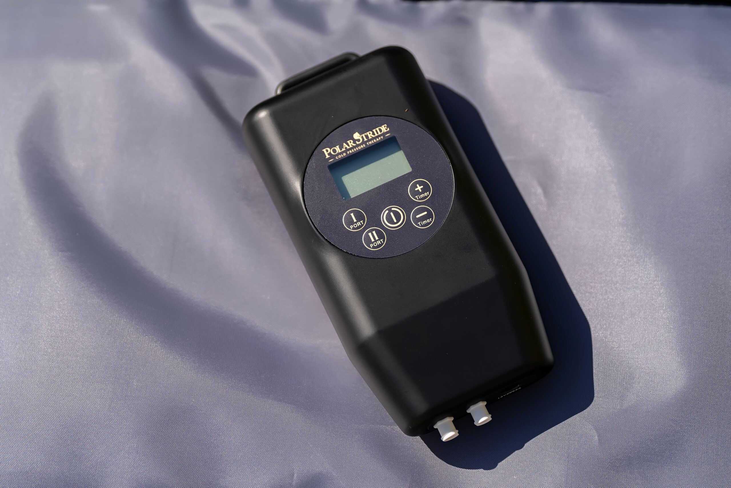 Polar Stride control unit shown at an angle, displaying the digital screen and timer controls